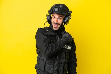Özel Tim 'in beyaz adamı sarı arka planda izole edilmiş ve zaferi kutluyor.