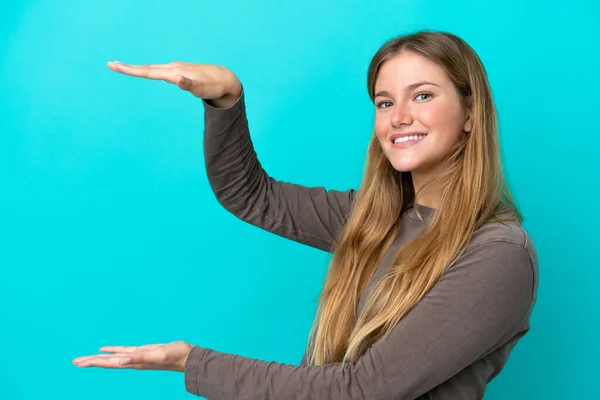 Ung Blond Kvinna Isolerad Blå Bakgrund Håller Copyspace För Att — Stockfoto