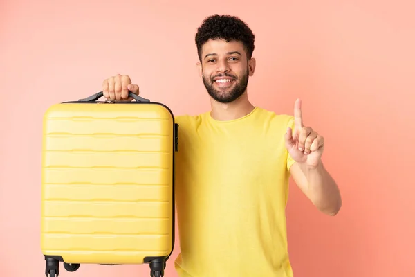 Jonge Marokkaanse Man Geïsoleerd Roze Achtergrond Vakantie Met Reiskoffer Tellen — Stockfoto