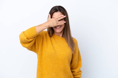 Beyaz arka planda izole edilmiş orta yaşlı beyaz bir kadın. Gözleri elleriyle kaplıyor ve gülümsüyor.