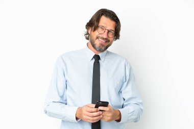 Üst düzey Hollandalı iş adamı beyaz arkaplanda izole edilmiş cep telefonuyla bir mesaj gönderiyor