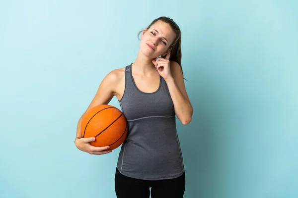 若いです女性プレーバスケットボール孤立した青の背景に疑問を持って — ストック写真
