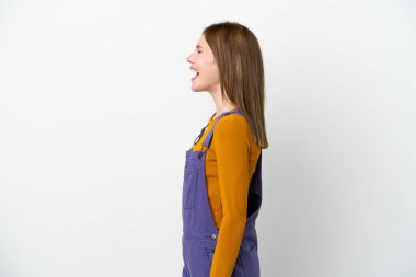 Beyaz arka planda izole edilmiş genç bir İngiliz kadın yan yana gülüyor.