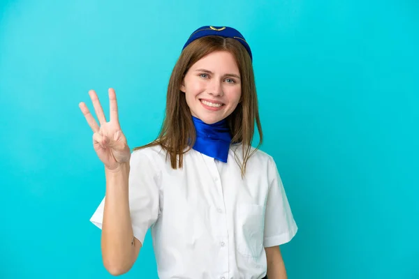 飛行機スチュワーデス英語の女性は幸せな青の背景に隔離され 指で3を数える — ストック写真