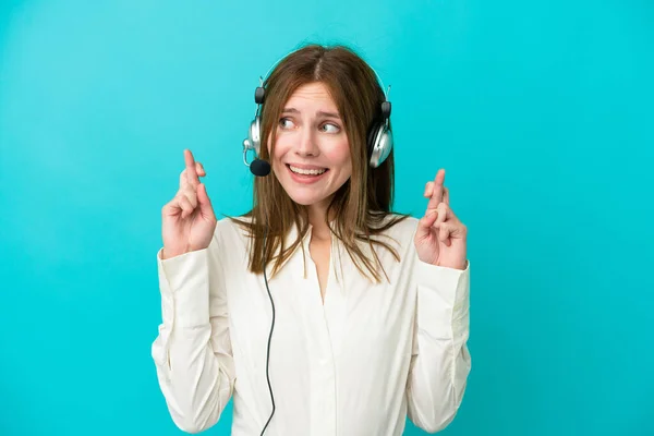 Telemarketer English Woman Working Headset Isolated Blue Background Fingers Crossing — Stock Photo, Image