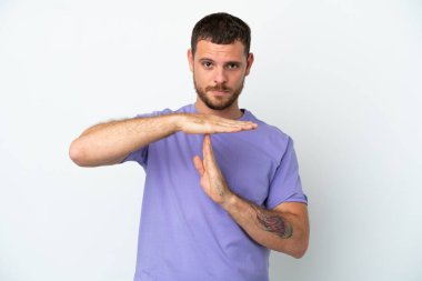 Genç Brezilyalı bir adam beyaz arka planda izole edilmiş bir şekilde jest yapıyor.
