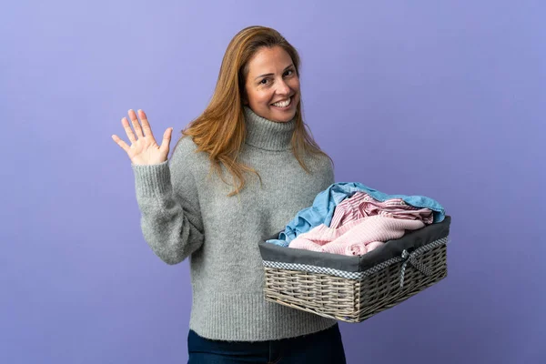 Frau Mittleren Alters Hält Einen Wäschekorb Isoliert Auf Lila Hintergrund — Stockfoto