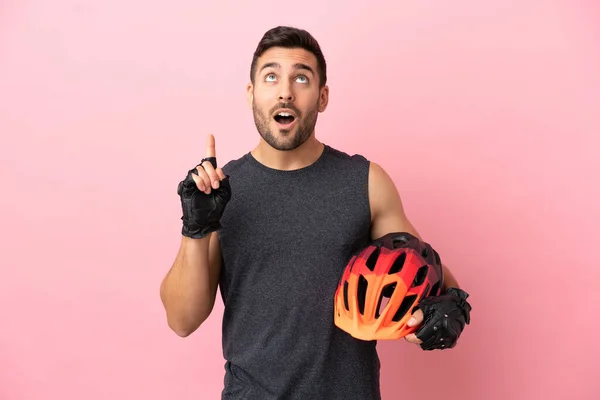 Young Cyclist Man Isolated Pink Background Thinking Idea Pointing Finger — 图库照片