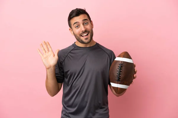 Young Caucasian Man Playing Rugby Isolated Pink Background Saluting Hand — Stock Photo, Image
