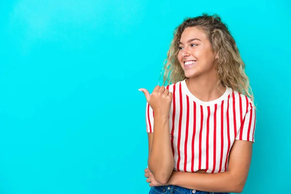 Menina Com Cabelo Encaracolado Isolado Fundo Azul Apontando Para Lado — Fotografia de Stock