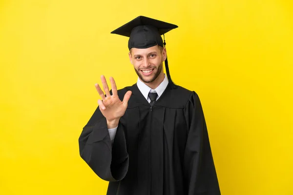 Junger Universitätsabsolvent Kaukasischer Mann Isoliert Auf Gelbem Hintergrund Glücklich Und — Stockfoto