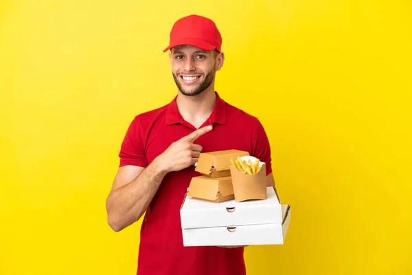 Pizza Delivery Man Picking Pizza Boxes Burgers Isolated Background Pointing — Stock Photo, Image