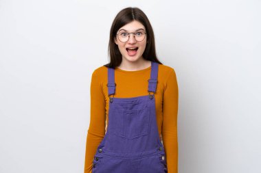 Mavi arka planda yalıtılmış genç bir Rus kadın. Şaşırtıcı bir yüz ifadesi var.