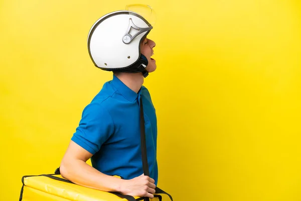 Young Brazilian Man Thermal Backpack Isolated Yellow Background Laughing Lateral —  Fotos de Stock