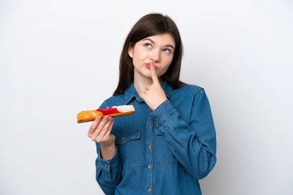 Young Russian Woman Holding Sashimi Isolated White Background Having Doubts — Stock Photo, Image