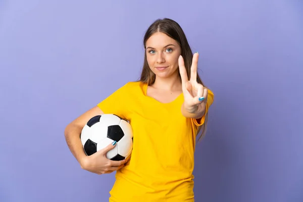 年轻的立陶宛女子足球运动员 被紫色背景隔离 面带微笑 并显示出胜利的迹象 — 图库照片