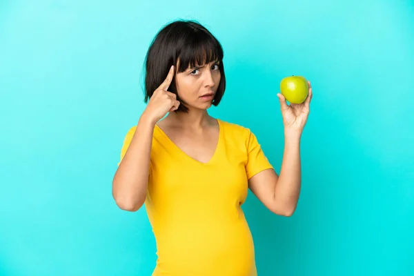 Pregnant Woman Holding Apple Isolated Blue Background Thinking Idea — Stockfoto