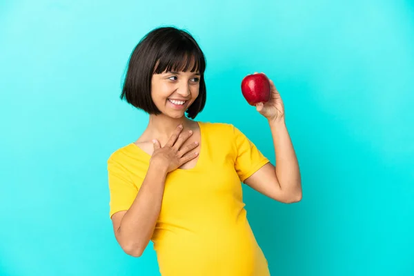 Pregnant Woman Holding Apple Isolated Blue Background Looking While Smiling — Stockfoto