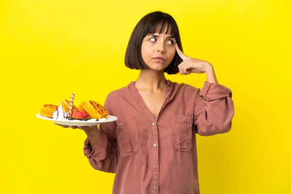 Pregnant Woman Holding Waffles Isolated Yellow Background Thinking Idea — Stock Photo, Image