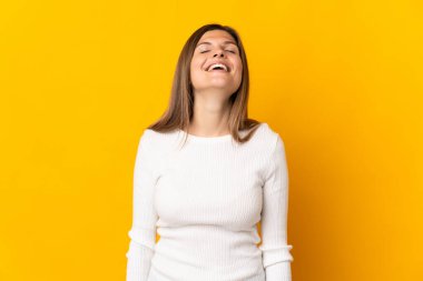 Genç Slovak kadın sarı arka planda yalnız gülüyor.