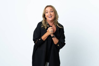 Orta yaşlı sarışın kadın soyutlanmış beyaz arka planda gülüyor.