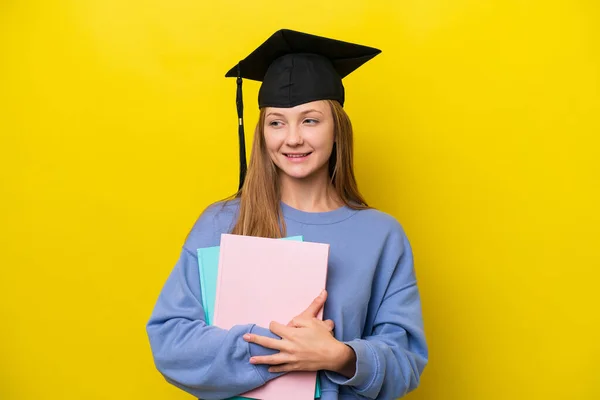 Young Student Russian Woman Isolated Yellow Background Looking Side Smiling — Fotografia de Stock