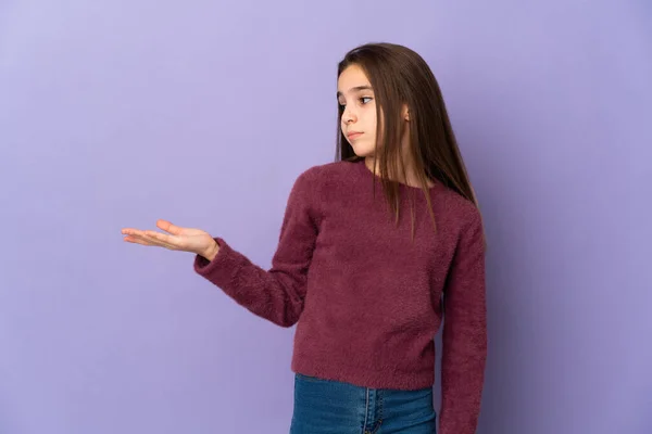Little Girl Isolated Purple Background Holding Copyspace Doubts — 图库照片