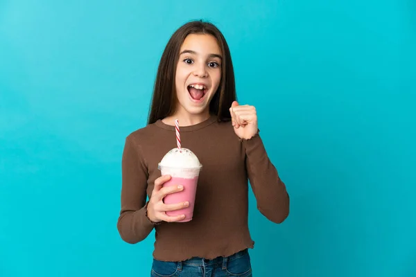 Liten Flicka Med Jordgubbsmjölkshake Isolerad Blå Bakgrund Firar Seger Vinnarposition — Stockfoto