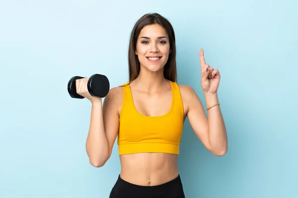Young Caucasian Woman Making Weightlifting Isolated Blue Background Pointing Great — Foto Stock