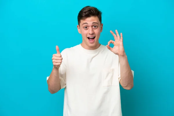 Young Handsome Brazilian Man Isolated Blue Background Showing Sign Thumb — Zdjęcie stockowe