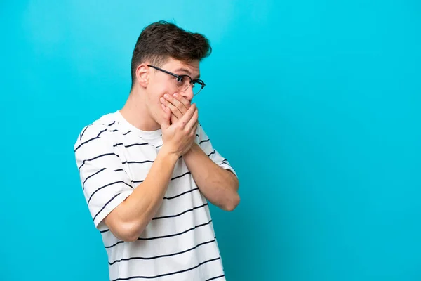 Young Handsome Brazilian Man Isolated Blue Background Covering Mouth Looking — Zdjęcie stockowe