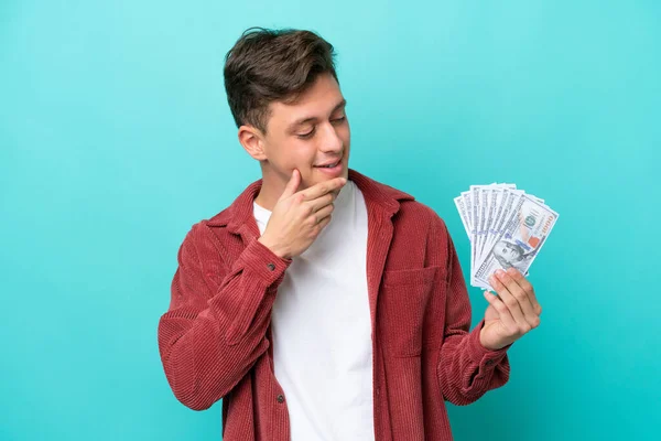 Young Brazilian Man Taking Lot Money Isolated Blue Background Looking — стоковое фото