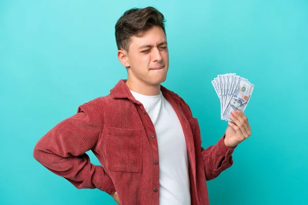 Young Brazilian Man Taking Lot Money Isolated Blue Background Suffering — стоковое фото