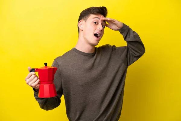 Young Brazilian Man Holding Coffee Pot Isolated Yellow Background Doing — Fotografia de Stock
