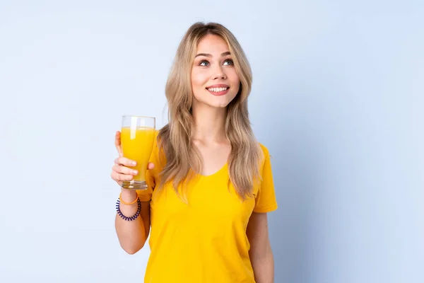 Teenager Russian Girl Holding Orange Juice Isolated Blue Background Looking — Stockfoto