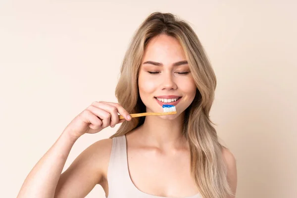 Teenager Blonde Girl Brushing Her Teeth Isolated Background — Stock Photo, Image