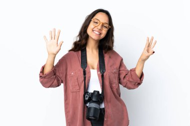 Young photographer woman over isolated white background counting eight with fingers
