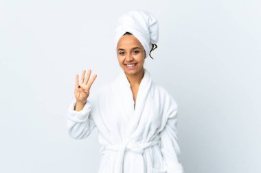 Young woman in bathrobe over isolated white background happy and counting four with fingers