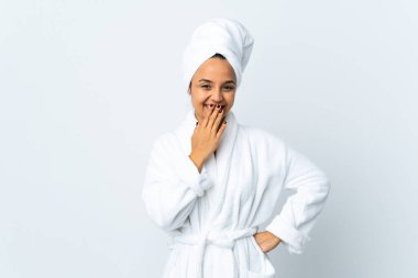 Young woman in bathrobe over isolated white background happy and smiling covering mouth with hand