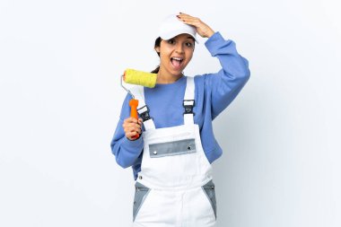 Painter woman over isolated white background surprised and pointing finger to the side