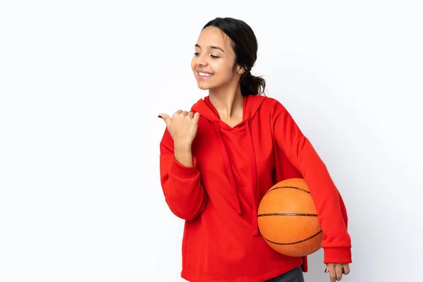 若いです女性は 製品を提示するために側面を指して隔離された白い背景の上にバスケットボールをプレイ — ストック写真