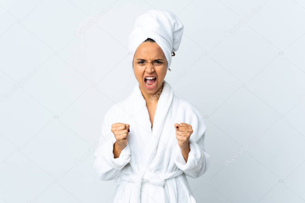 Young woman in bathrobe over isolated white background frustrated by a bad situation