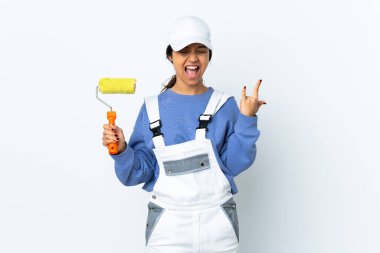 Painter woman over isolated white background making horn gesture