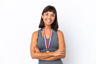 Young mixed race woman with medals isolated on white background keeping the arms crossed in frontal position