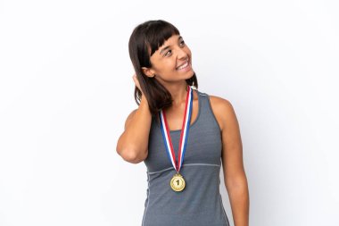Young mixed race woman with medals isolated on white background thinking an idea