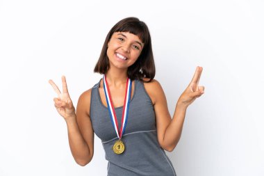 Young mixed race woman with medals isolated on white background showing victory sign with both hands
