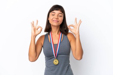Young mixed race woman with medals isolated on white background in zen pose
