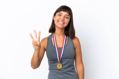 Young mixed race woman with medals isolated on white background happy and counting three with fingers