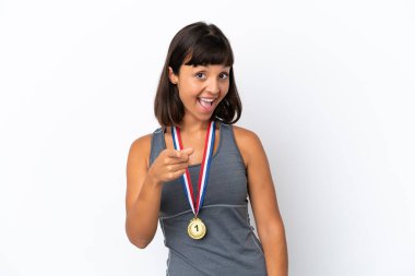 Young mixed race woman with medals isolated on white background points finger at you with a confident expression