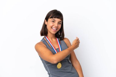 Young mixed race woman with medals isolated on white background pointing back